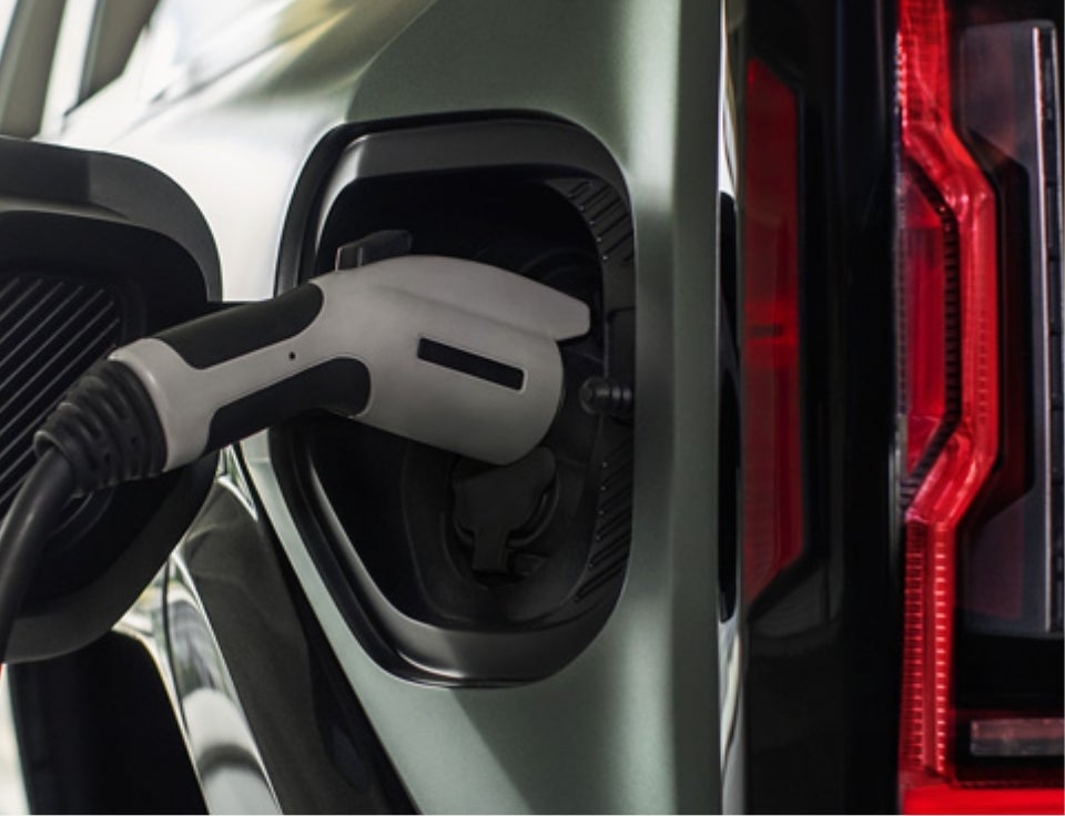 Close up of charging port with charger plugged in on a GMC Hummer EV SUV - Marty's GMC in kingston MA
