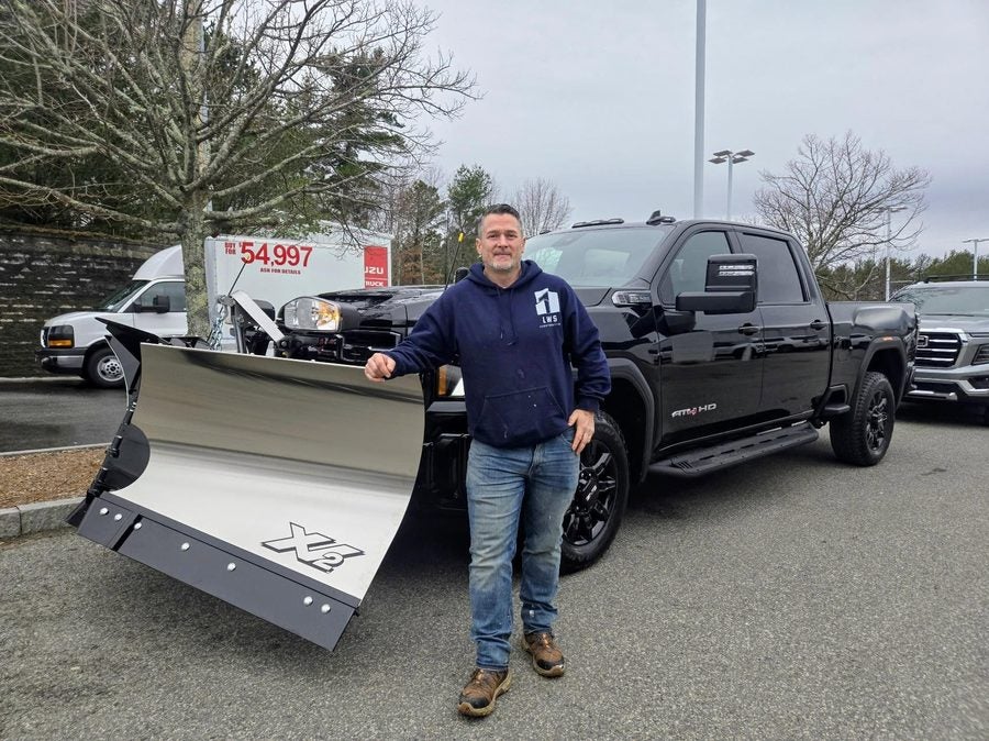 A contractor picking up his GMC Sierra AT4 HD with a new Fisher XV2 stainless v-plow at Marty's GMC