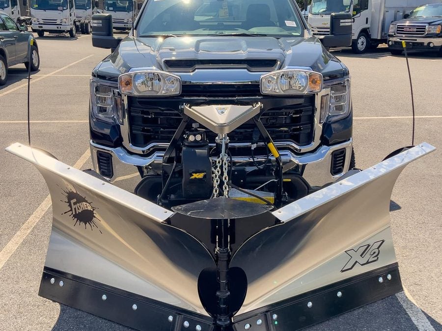 Front view of a Fisher XV2 v-plow in the V position on a black GMC Sierra HD